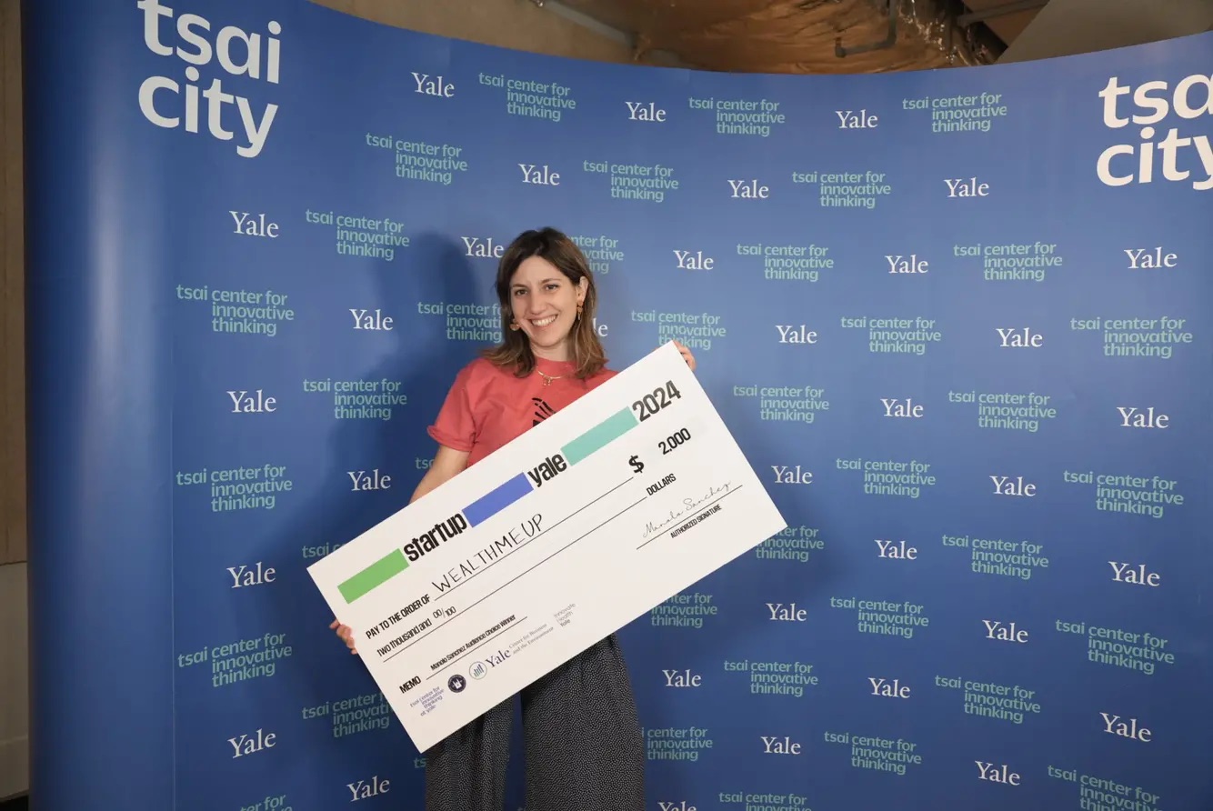 Yale student holding a check at Startup Yale