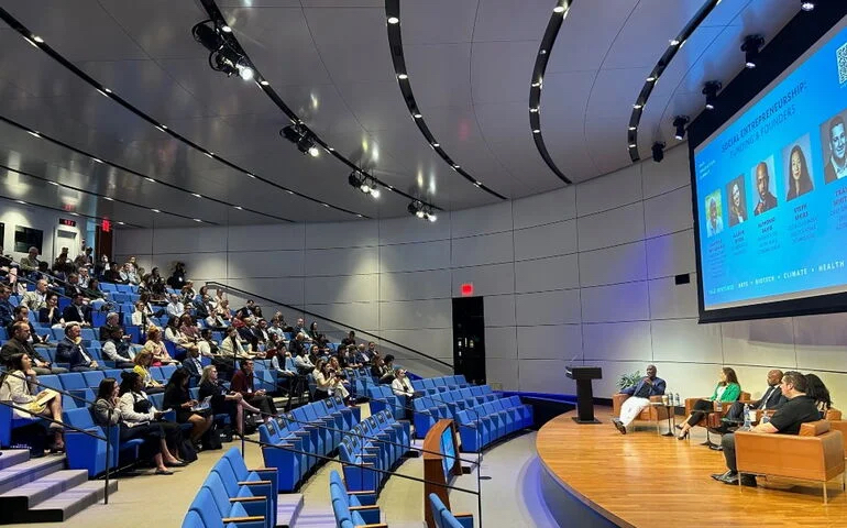 Attendees of the 2024 Yale Innovation Summit listen to a moderated discussion on social entrepreneurship in the Yale School of Management's Zhang Auditorium.